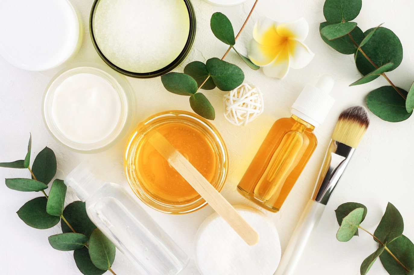 Skincare products with leaves and flowers.